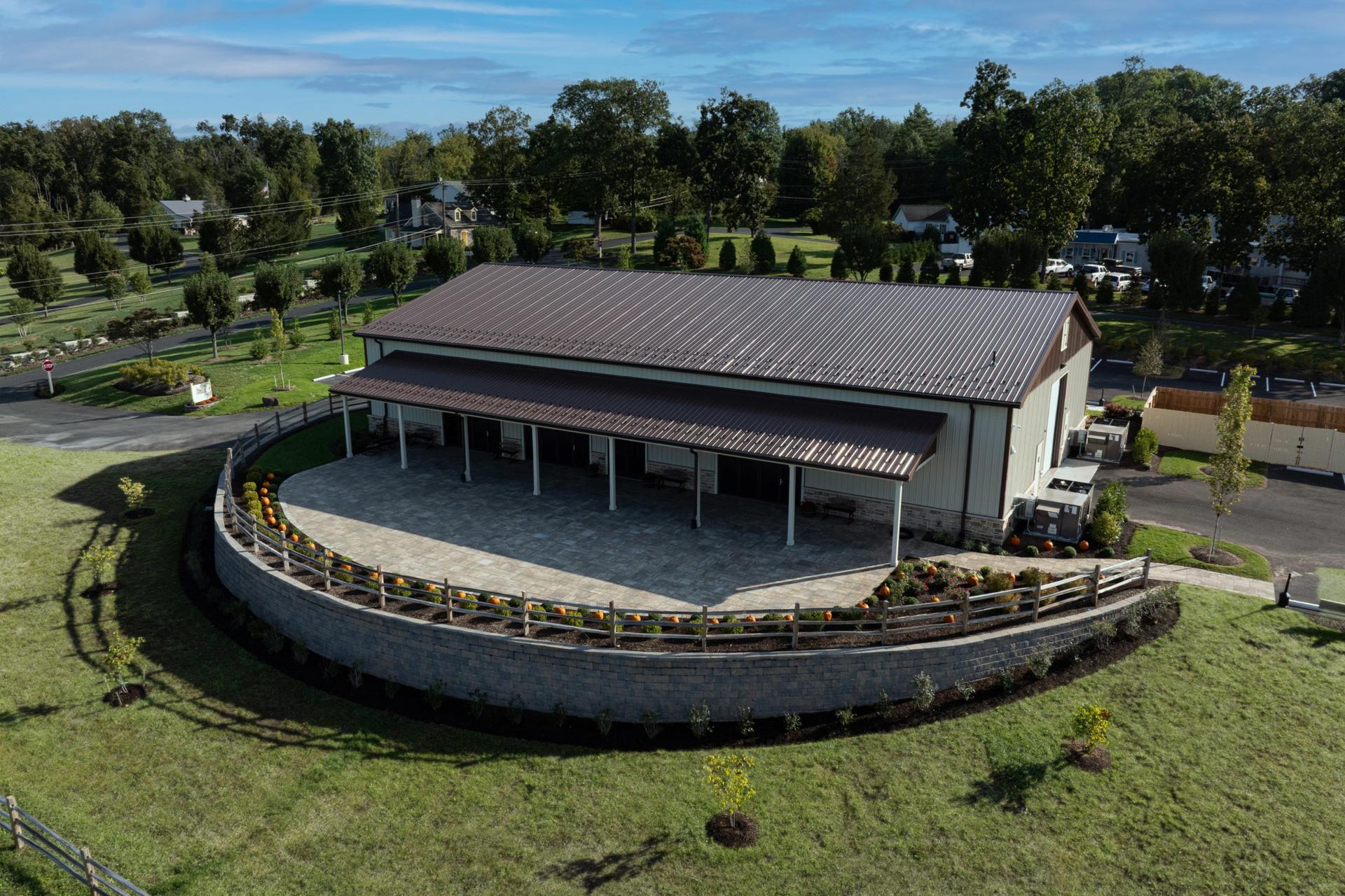 Aerial view of the Welcome Center with its covered porch and curved stone terrace