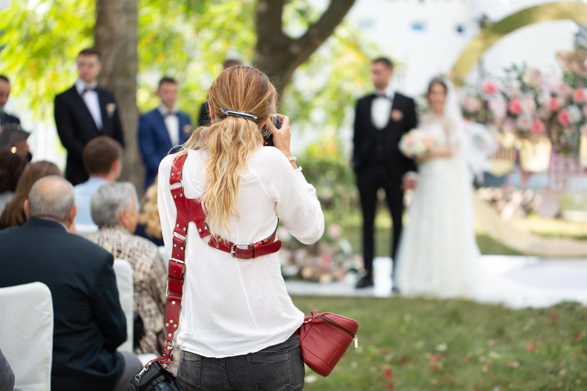 A wedding photographer capturing a couple at their ceremony